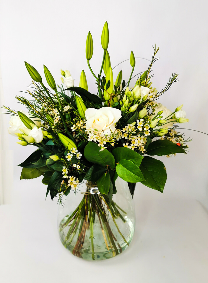 <h2>Vase of Classic White and Green Flowers - Hand Delivered</h2>
<br>
<ul>
<li>Approximate Dimensions: 65cm x 45cm</li>
<li>Flowers arranged by hand into a beautiful glass vase</li>
<li>To give you the best occasionally we may make substitutes</li>
<li>Our flowers backed by our 7 days freshness guarantee</li>
<li>For delivery area coverage see below</li>
</ul>
<br>
<h2>Flower Delivery Coverage</h2>
<p>Our shop delivers flowers to the following Liverpool postcodes L1 L2 L3 L4 L5 L6 L7 L8 L11 L12 L13 L14 L15 L16 L17 L18 L19 L24 L25 L26 L27 L36 L70 If your order is for an area outside of these we can organise delivery for you through our network of florists. We will ask them to make as close as possible to the image but because of the difference in stock and sundry items it may not be exact.</p>
<br>
<h2>Vase of Flowers | Flowers in Water</h2>
<p>These beautiful lilies and roses hand-arranged by our professional florists into a beautiful glass vase are a delightful choice from our new collection. This classic white and green vase of flowers would make the perfect gift for any occasion or to let someone know you are thinking of them.</p>
<p>The advantage of having a vase of flowers made this way is that they are artfully arranged by our florists and tied so that they stay in the display.</p>
<p>They are not out of water during delivery and this means they look their very best on the day they arrive and continue to delight for days after.</p>
<p>Being delivered in a vase means the recipient does not need to already have a vase or arrange them they can just put them down and enjoy.</p>
<p>Featuring 3 white oriental lilies, 5 white large-headed roses, 3 white lisianthus, and white waxflower or gypsophila hand-arranged with mixed seasonal foliages.</p>
<br>
<h2>Eco-Friendly Liverpool Florists</h2>
<p>As florists we feel very close earth and want to protect it. Plastic waste is a huge problem in the florist industry so we made the decision to make our packaging eco-friendly.</p>
<p>To achieve this we worked with our packaging supplier to remove the lamination off our boxes and wrap the tops in an Eco Flowerwrap which means it easily compostable or can be fully recycled.</p>
<p>Once you have finished enjoying your flowers from us they will go back into growing more flowers! Only a small amount of plastic is used as a water bubble and this is biodegradable.</p>
<p>Even the sachet of flower food included with your bouquet is compostable.</p>
<p>All our bouquets have small wooden ladybird hidden amongst them so do not forget to spot the ladybird and post a picture on our social media pages to enter our rolling competition.</p>
<br>
<h2>Flowers Guaranteed for 7 Days</h2>
<p>Our 7-day freshness guarantee should give you confidence that we will only send out good quality flowers.</p>
<p>Leave it in our hands we will create a marvellous bouquet which will not only look good on arrival but will continue to delight as the flowers bloom.</p>
<br>
<h2>Liverpool Flower Delivery</h2>
<p>We are open 7 days a week and offer advanced booking flower delivery same-day flower delivery 3-hour flower delivery. Guaranteed AM PM or Evening Flower Delivery and also offer Sunday Flower Delivery.</p>
<p>Our florists deliver in Liverpool and can provide flowers for you in Liverpool Merseyside. And through our network of florists can organise flower deliveries for you nationwide.</p>
<br>
<h2>The Best Florist in Liverpool your local Liverpool Flower Shop</h2>
<p>Come to Booker Flowers and Gifts Liverpool for your beautiful flowers and plants. For that bit of extra luxury we also offer a lovely range of finishing touches such as wines champagne locally crafted Gin and Rum Vases Scented Candles and Chocolates that can be delivered with your flowers.</p>
<p>To see the full range see our extras section.</p>
<p>You can trust Booker Flowers and Gifts of delivery the very best for you.</p>
<p><br /><br /></p>
<p><em>5 Star review on Yell.com</em></p>
<br>
<p><em>Thank you Gemma for your fabulous service. The flowers are of the highest quality and delivered with a warm smile. My sister was delighted. Ordering was simple and the communications were top-notch. I will definitely use your services again.</em></p>